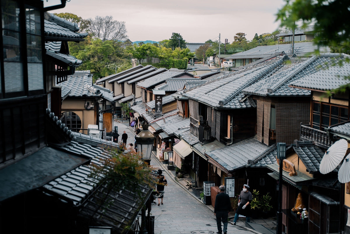 Traditional rooftops and a sloping pedestrian street in Kyoto's Higashiyama district