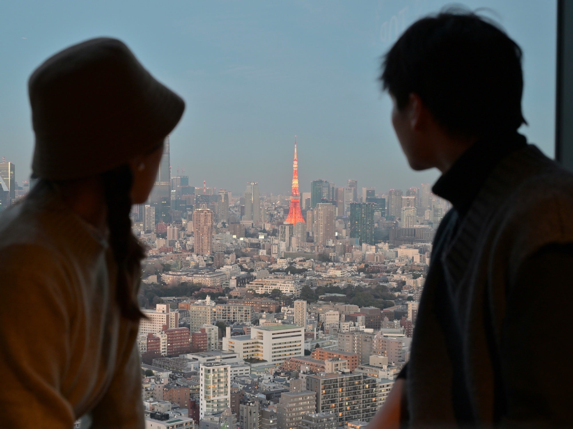 Couple looking across the Tokyo skyline toward Tokyo Tower
