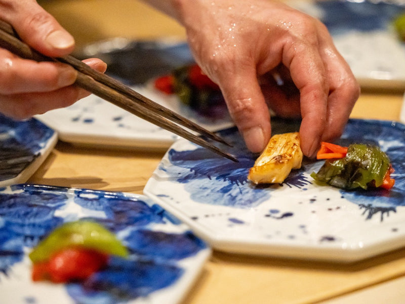 Chef plating a Japanese fine dining dish