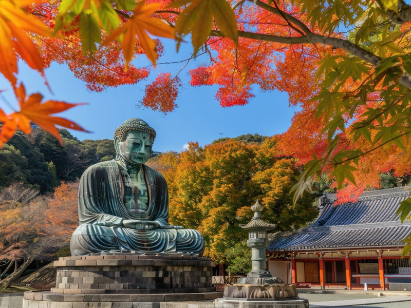 Great Buddha and temple buildings framed by autumn leaves