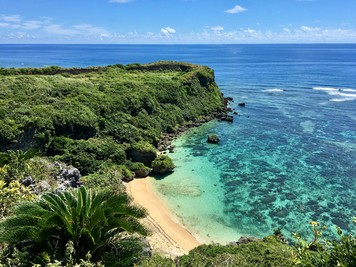 Clear turquoise water along a green Okinawan coastline