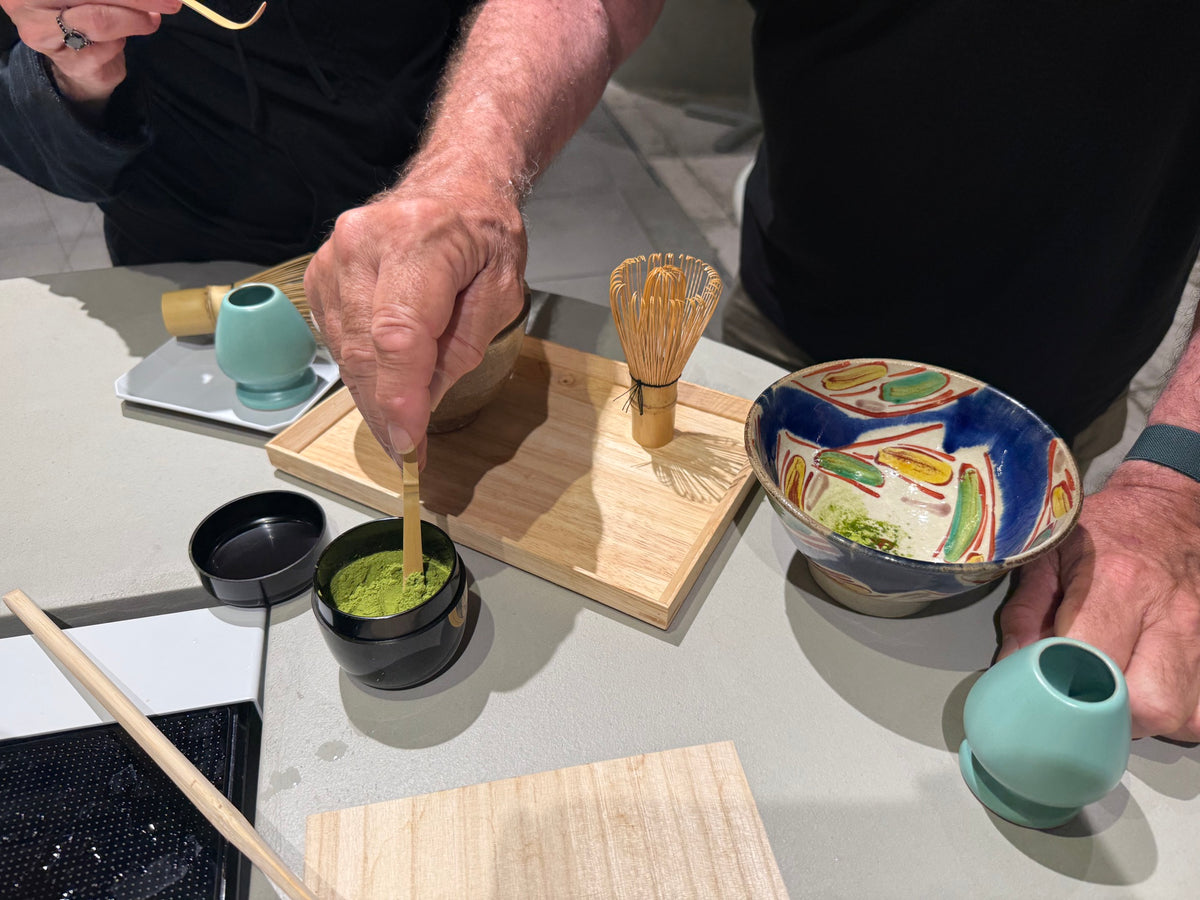 Guest preparing matcha with traditional tea utensils