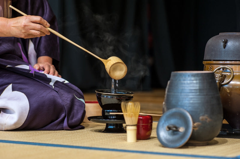 Hot water being poured from a ladle during a Japanese tea ceremony.